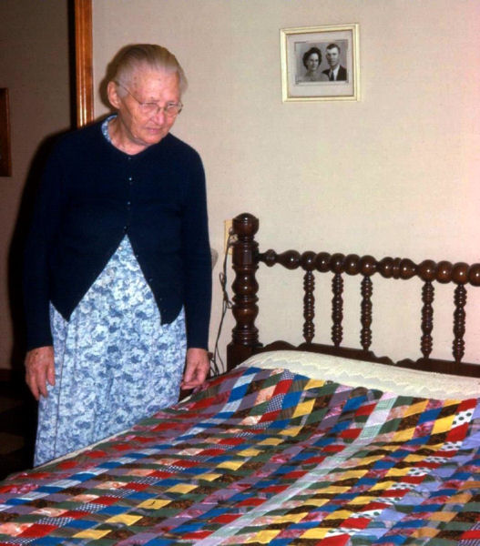 Grossmama inspects one of her quilts, Abilene, January 29,1966